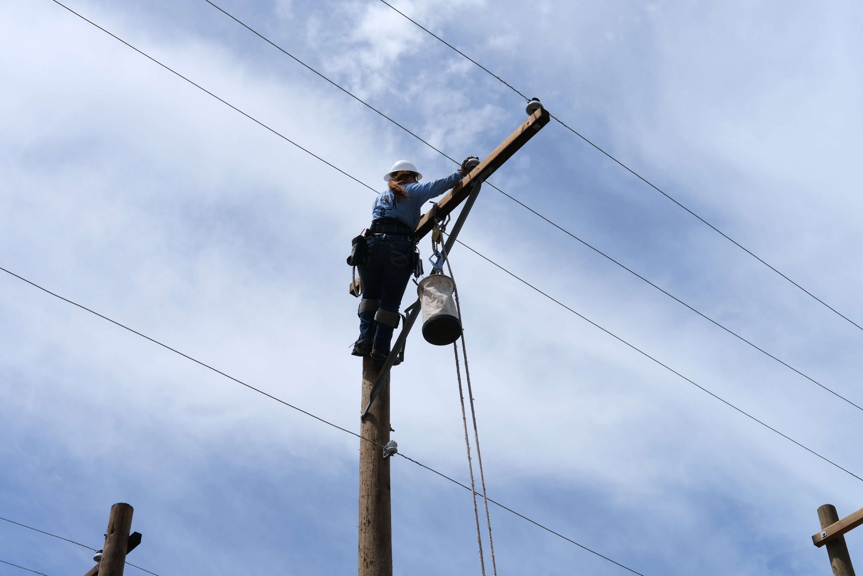 Rylee Gunn works atop a utility pole during the APPA Lineworkers Rodeo. 