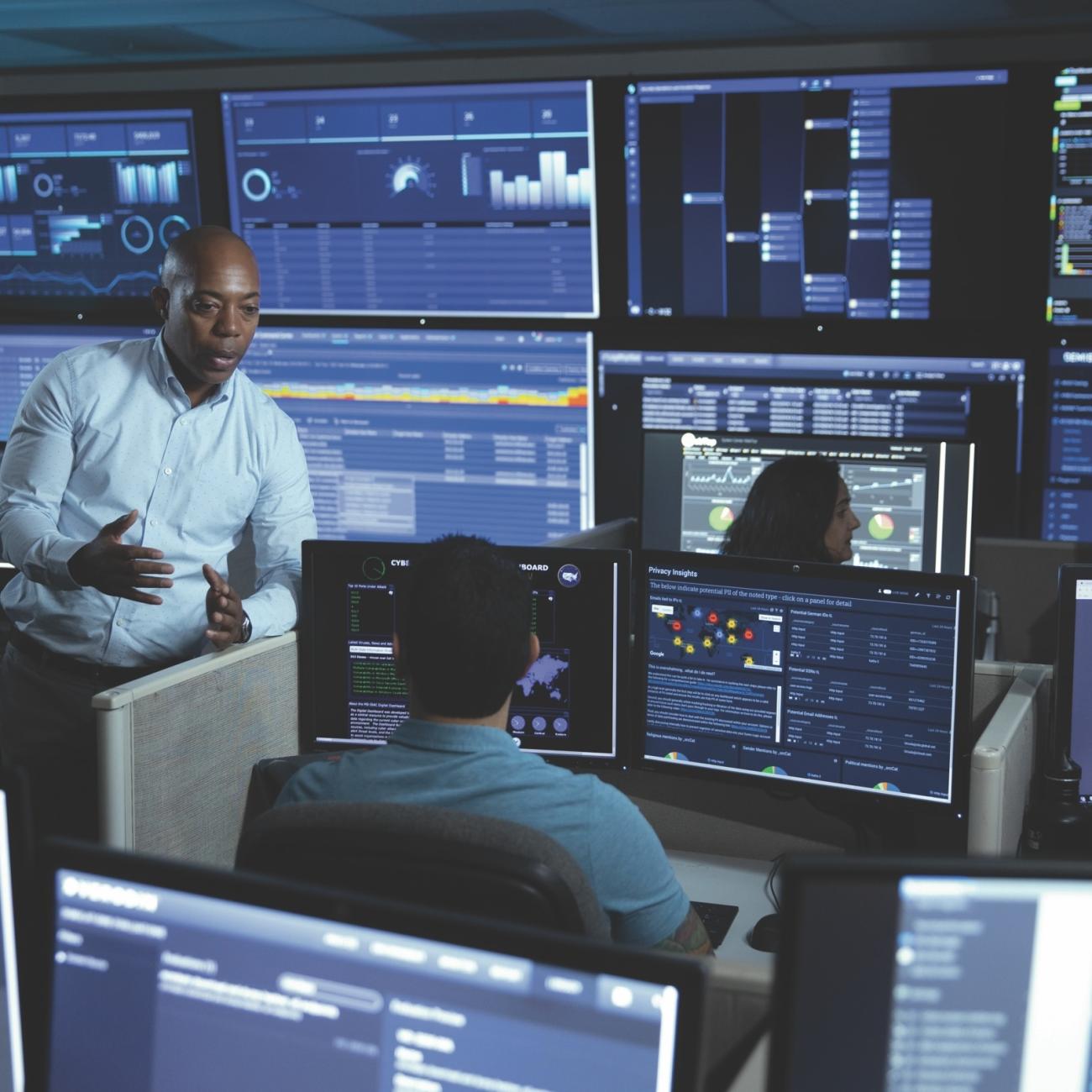 Two people talking in a control room