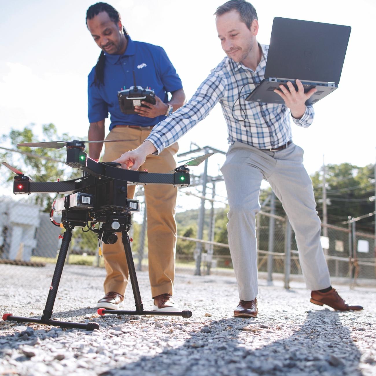 Two men preparing a drone