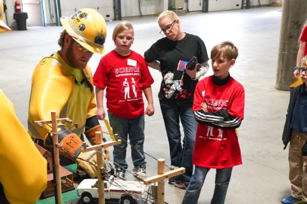 Lincoln Electric System employees doing a demonstration at a school science fair