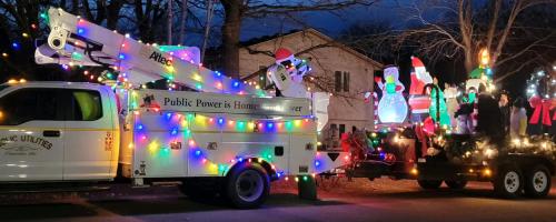 Princeton Public Utilities bucket truck decorated with holiday lights for a parade