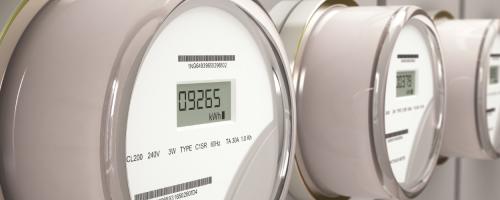 Close cropped view of a line of electric meters