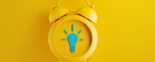 yellow alarm clock on yellow background